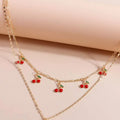 GOLD multi-layered necklace adorned with cherry and heart pendants